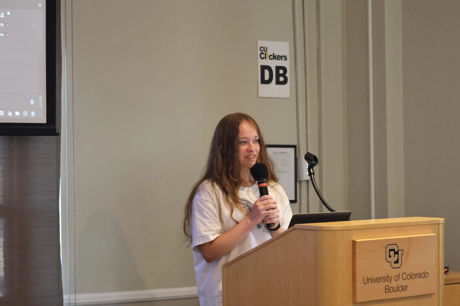 A participant speaks at a podium during an Evoke challenge at CU Boulder.