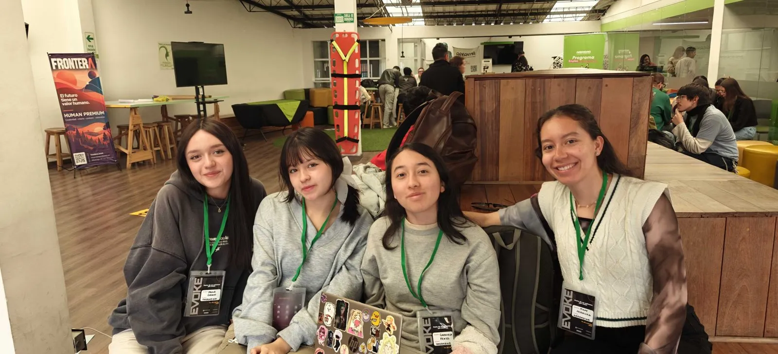 Four participants wearing Evoke badges smile at the camera.