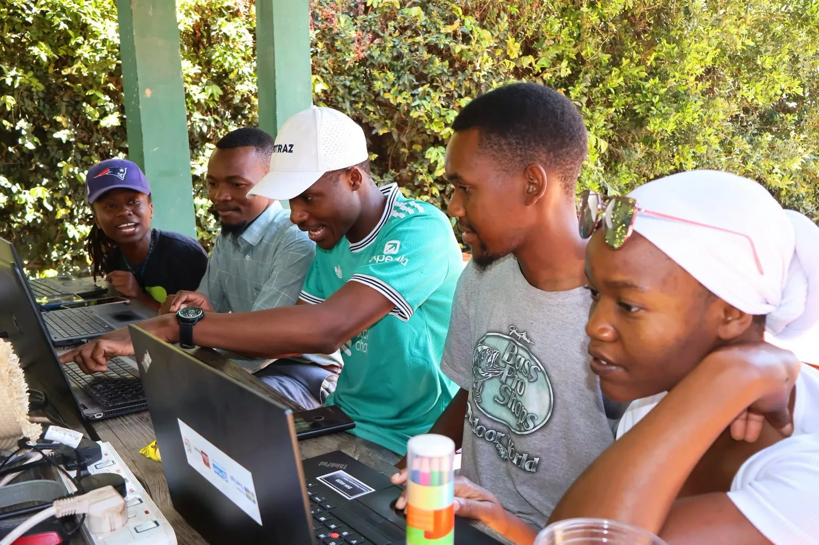 A team works together on laptops at Impact Hub Harare.